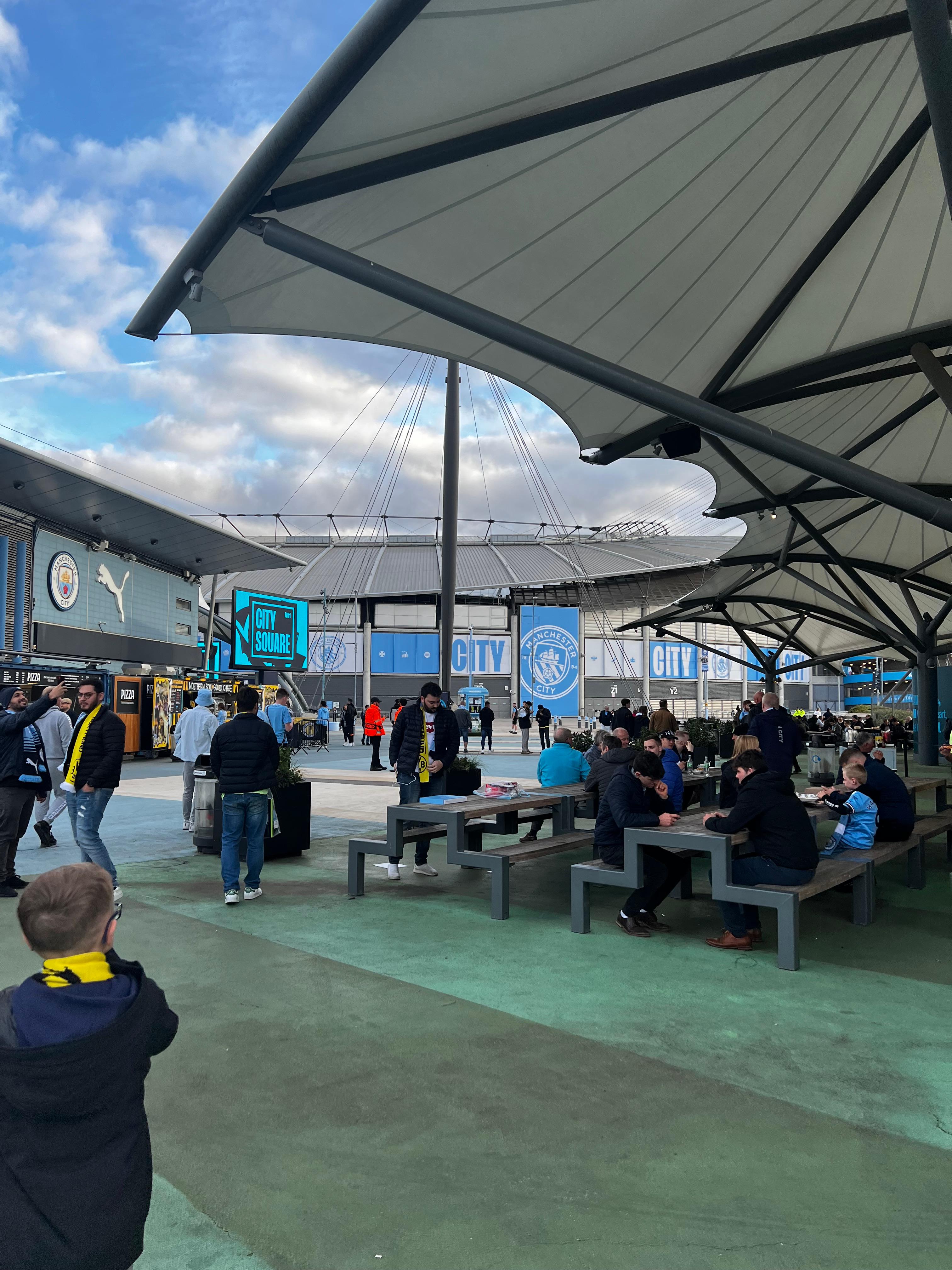 Etihad Stadium City Square fan zone Manchester City matchday food stalls seating area Premier League
