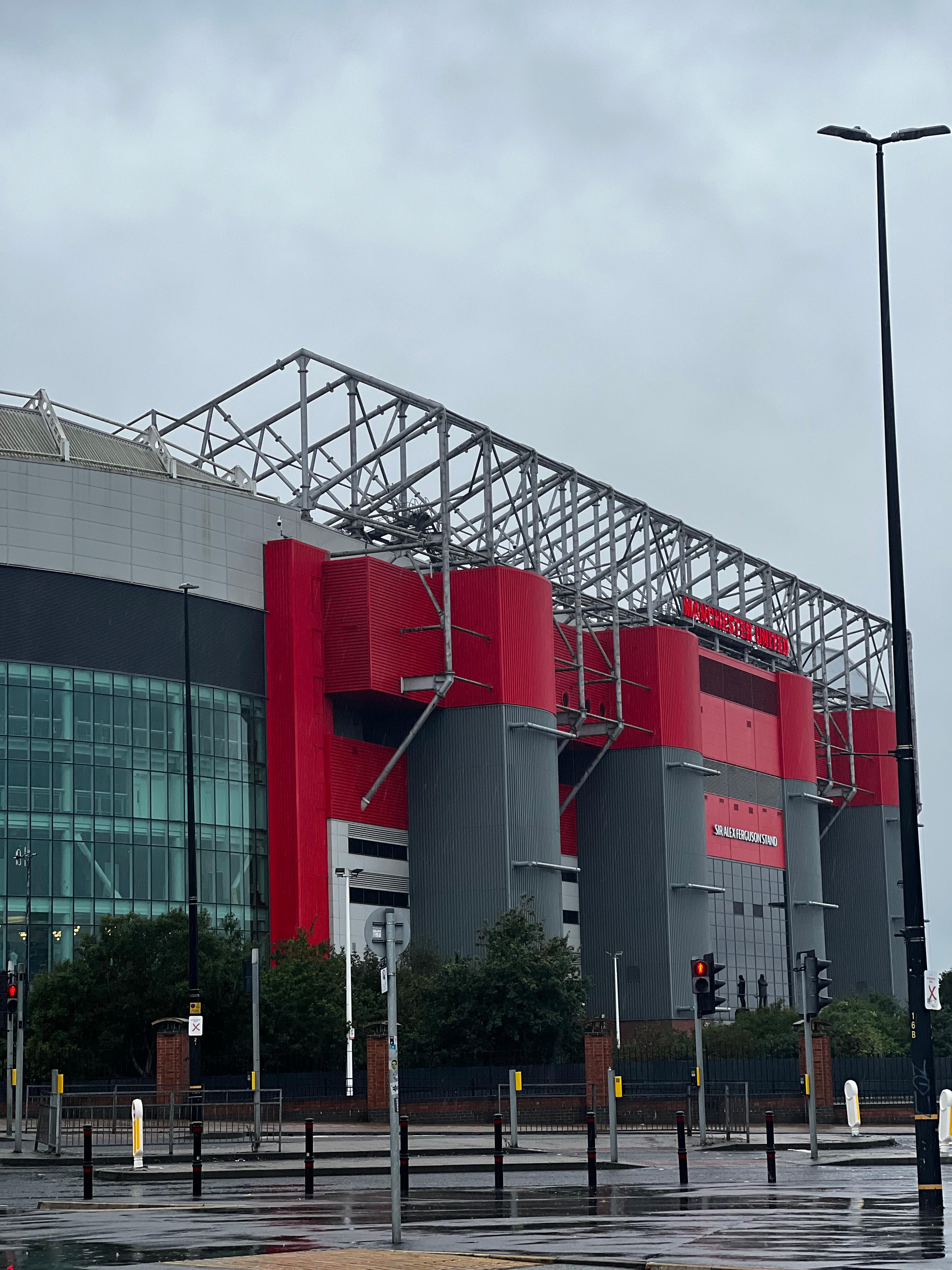 Old Trafford stadium exterior Sir Alex Ferguson Stand Manchester United red facade iconic roof structure Theatre of Dreams