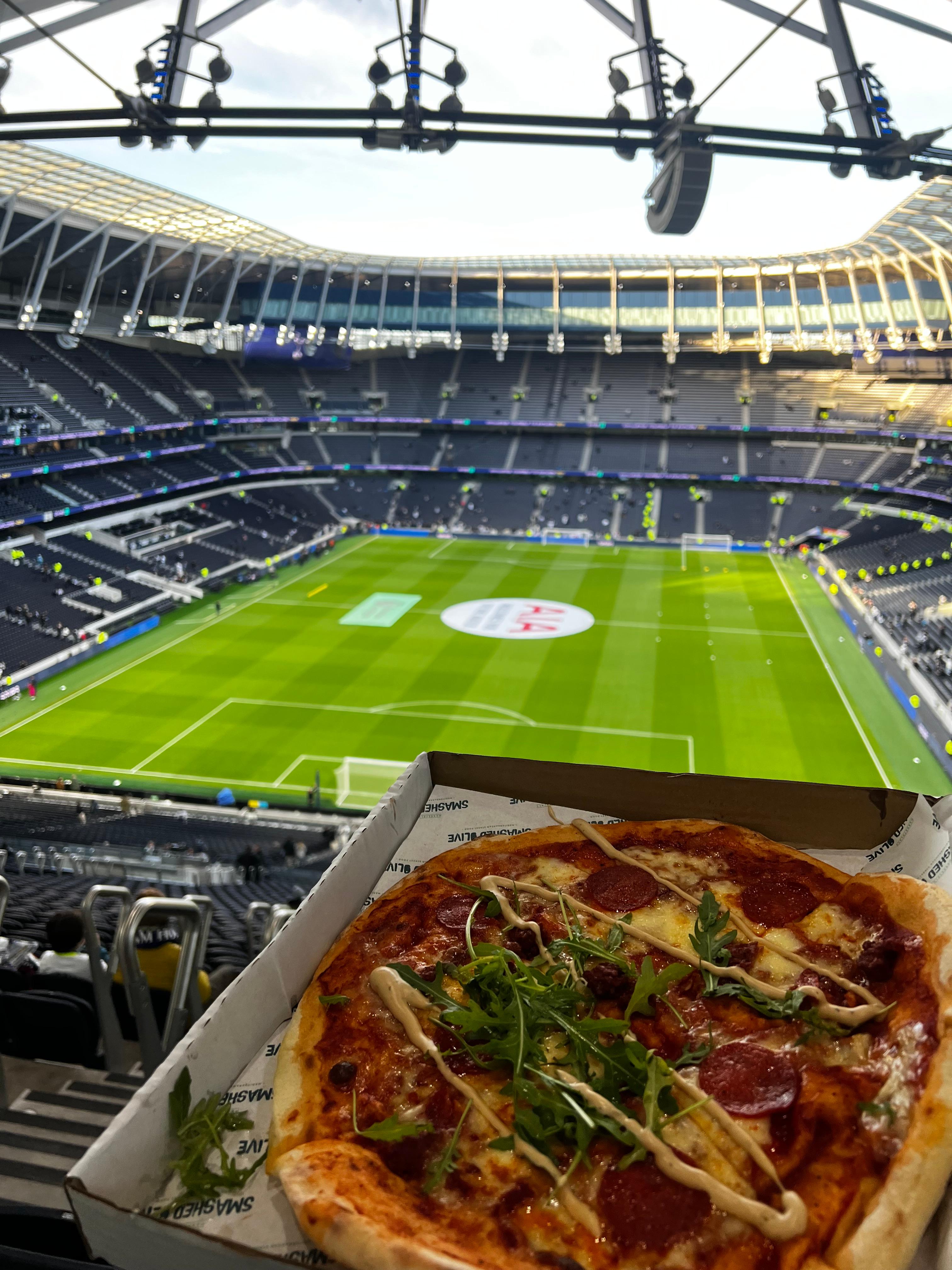 North Stand view inside Tottenham Hotspur Stadium with pitch and food